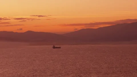 Cargo ship sailing on ocean water during golden sunset 스톡 동영상 337297430