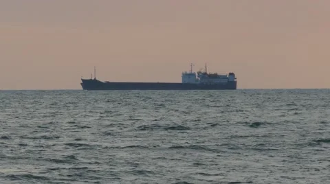 Cargo ship sailing from open sea on the sunset time. Stock Footage 51133937