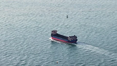 Cargo ship sailing in open water on the ocean Stock Footage 333656622