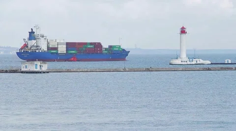 Cargo ship sailing  past the lighthouse to open sea Video stock 57881947