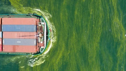 Cargo ship sailing on pollution sea with aerial shot. Stock Footage 112600706