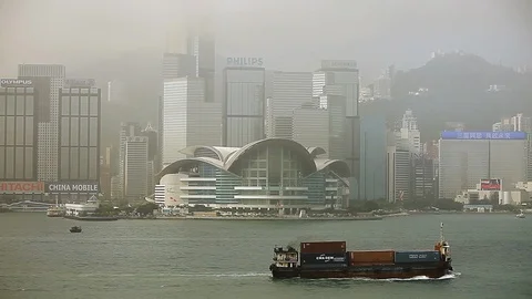 Cargo ship sailing in the river in front of Hong Kong skyline Stock Footage 97101756