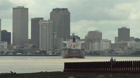 Cargo ship sailing in sea towards cityscape during dusk Stock Footage 84512716