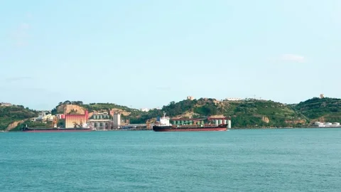 Cargo ship sailing on the Tagus Tejo River Stock Footage 310677233