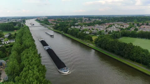 A cargo ship sailing through a canal Stock Footage 167901060