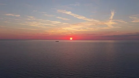 Cargo Ship Sailing Toward Sunset on Calm Mediterranean Sea Видео 337191079