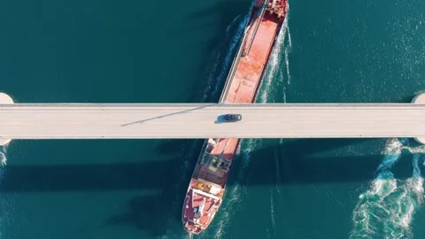 Cargo ship sailing under a bridge in Lofoten islands, Norway. Stock Footage 337350823