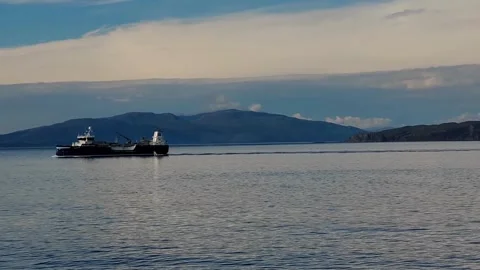 Cargo ship sails in the dark northern sea Stock Footage 293088195