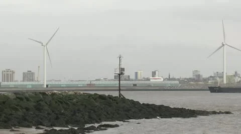 Cargo ship sails on Mersey through frame past wind turbines.mp4 Video stock 21926167