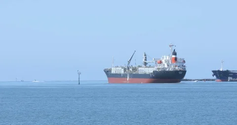 Cargo Ship Sails Out to Open Water on Calm Day Stock Footage 129216746