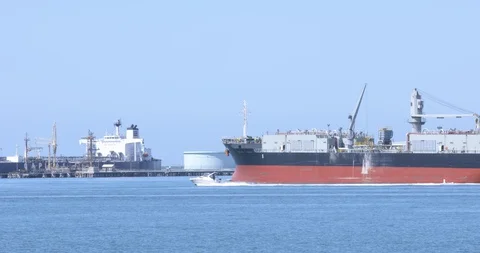Cargo Ship Sails Out Past Docks Stock Footage 129228439