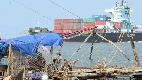 Cargo ship sails past the coast Stock Footage 147554596