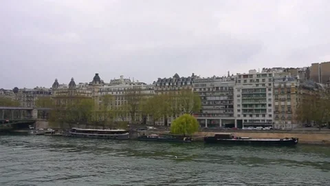 Cargo ship sails on the seine river in paris on a cloudy winter day. Stock Footage 173552499