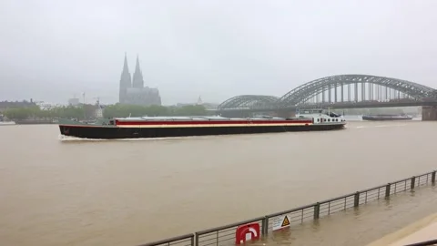 A cargo ship sails through the high water of the Rhine Stock Footage 157788014