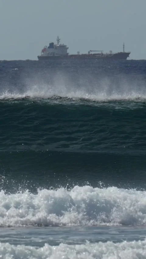Cargo ship in the sea at day time.Vertical video Stock Footage 302423154
