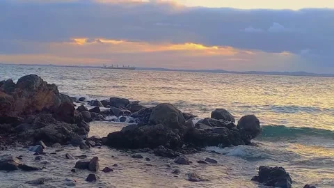 A cargo ship at sea at sunset Stock Footage 320056907