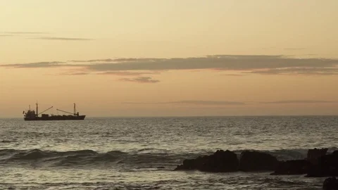 Cargo Ship off the shore of Easter Island at golden hour Stock Footage 77167781