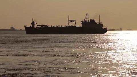 Cargo ship silhouette at sunset Stock Footage 78056856