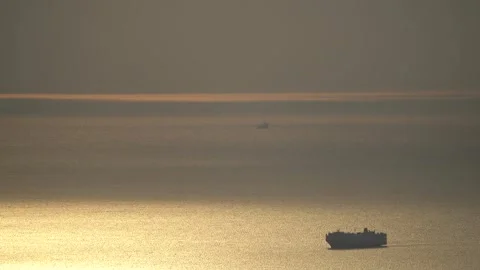 The cargo ship is slowly moving towards the port Stock Footage 285966907