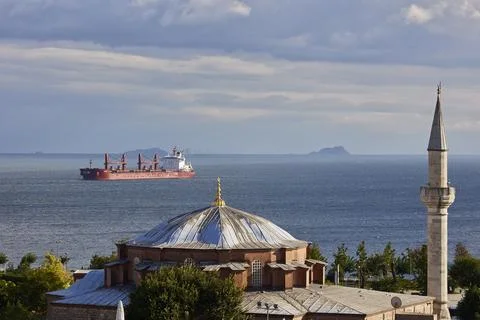 Cargo ship standing on the roadstead view from the city Stock Photos