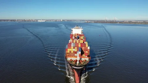 A Cargo Ship Steams Towards The Open Ocean Out Of A Harbor Stock Footage 102184743