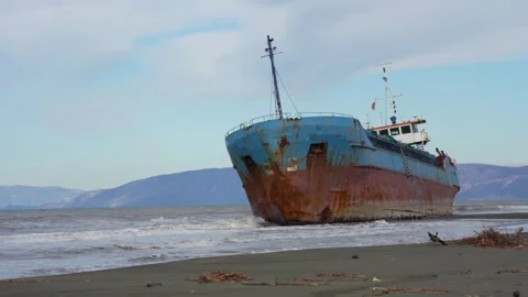 Cargo Ship Stranded on Sandy Shore During Winter Calm After Powerful Storm Stock Footage 331574423