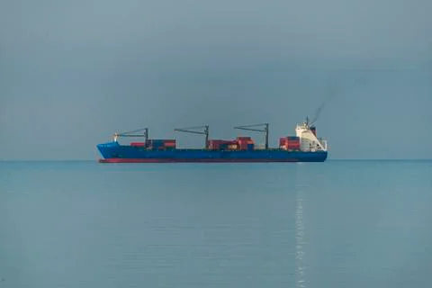 Cargo ship in the sunlight Stock Photos