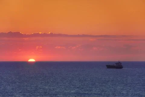 Cargo ship at sunset Stock Photos