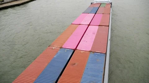 Cargo ship transporting colorful containers through calm waterway Stock Footage 319910740