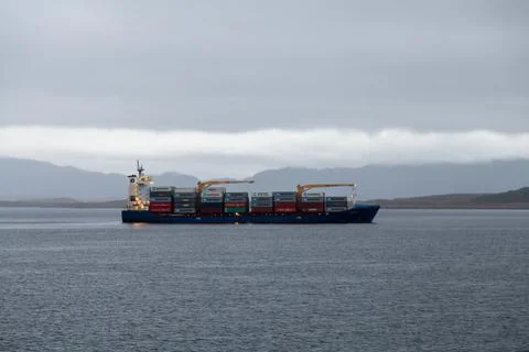 Cargo ship transporting containers in the ocean Stock Photos