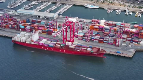 Cargo ship unloading at a busy container terminal in a bustling maritime port Stock Footage 334789465
