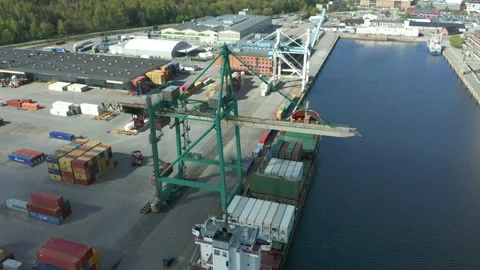 Cargo ship unloading containers at industrial terminal dock Stock Footage 130647605