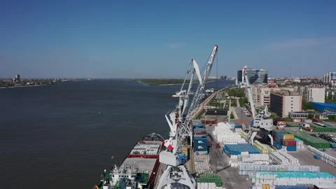 Cargo ship unloading containers at river port 動画素材 347518044
