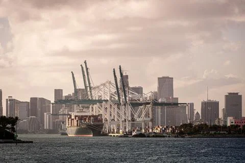Cargo ship unloading during sunset at Miami harbour Stock Photos