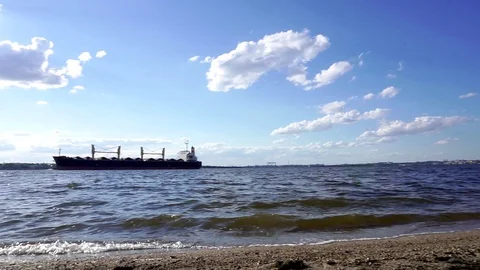 Cargo shipBig container cargo freight ship vessel sailing in the distance in Stock Footage 95222826