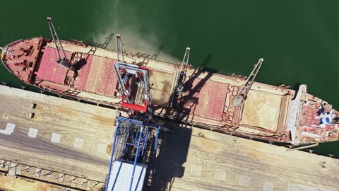 Cargo ships load goods at a shipping dock in a busy port during daylight hours Vídeos de archivo 340150828