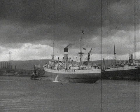 Cargo ships loading up coal at Glasgow harbour, Scotland 1950s Video stock 146078663