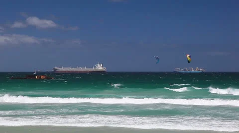 Cargo Ships on Ocean Close to Breaking Waves with Kite Surfers Video stock 23747129