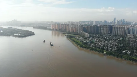 Cargo ships sail through the dirty water of the Pearl River. Stock Footage 113667006
