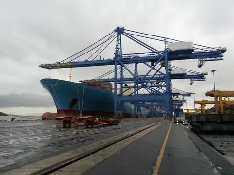 Cargo terminal for loading bulk cargo of iron ore by ship cranes and grabs Stock Photos