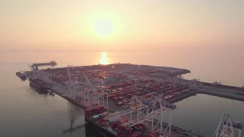 Cargo terminal loading shipping containers onto cargo ships, aerial footage Video stock 219785177