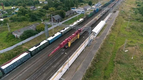 Cargo train and self-propelled rail-laying train in motion. Aerial view Stock-Footage 201961740