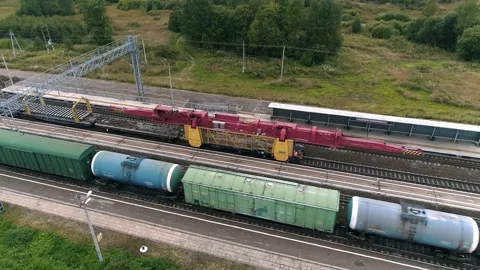 Cargo train and self-propelled rail-laying train in motion. Aerial view Video stock 201961741