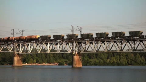 Cargo train on the bridge crossing the river Stock Footage 47707323