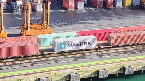Cargo train carrying shipping containers. Including Maersk container. Moving Stock Footage 321943659