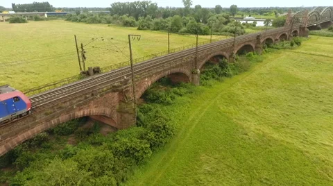 Cargo train crossing a railway bridge Stock Footage 64526764