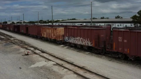 Cargo Train with Graffiti Pulling away Aerial Stock Footage 171297540