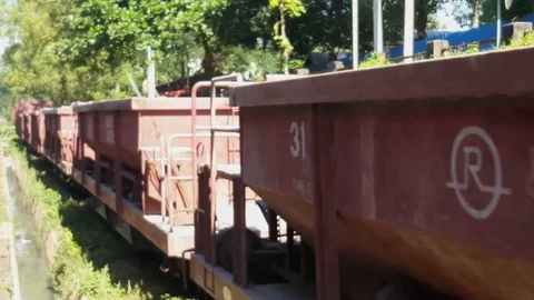 Cargo train in motion up close, sunny day, train tracks, grass, Yangon, Myanmar Stockbeeldmateriaal 78276593