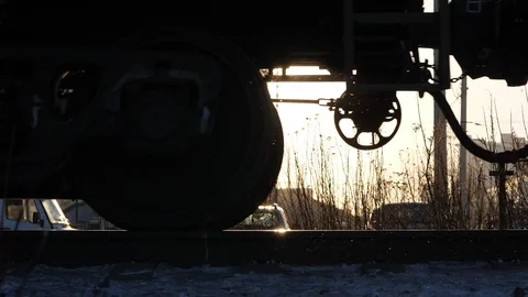 Cargo train move at rails, low close shot of bogie and wheels, sun flash Video stock 85508715