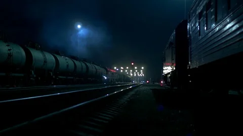 Cargo Train Moves at Some Railway Station With a Lot of Traffic Lights at Night Video stock 104164319